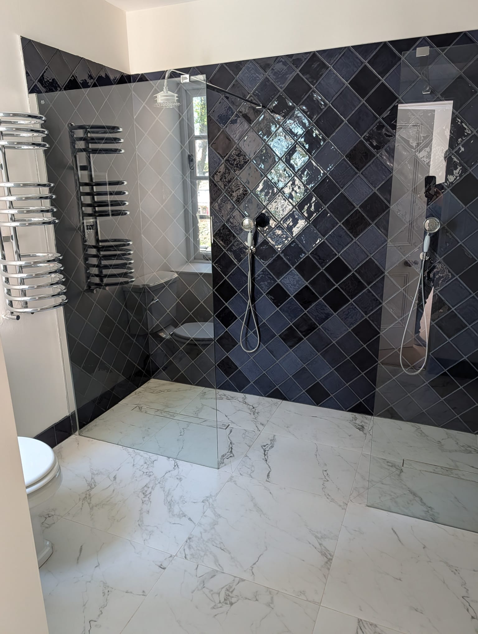 Navy diamond shower tiling with marble floor by SF Plumbing & Tiling, Leicester